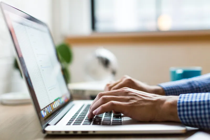 A person on a laptop using a user interface